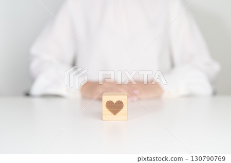 Hand holding heart block for health care, love, organ donation, charity, happy family, wellbeing and insurance concepts. world heart day, health day and mental health day 130790769