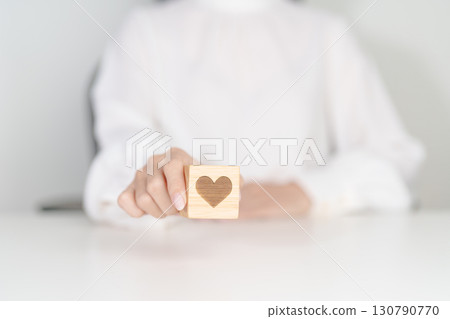 Hand holding heart block for health care, love, organ donation, charity, happy family, wellbeing and insurance concepts. world heart day, health day and mental health day 130790770