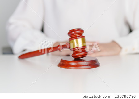 Woman Hand hold judge gavel. Law, lawyer, judgment, justice auction and bidding concept 130790786
