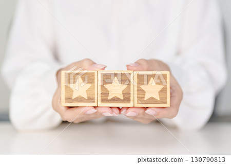 hand show Star block. Customer choose rating for user reviews. Service rating, ranking, customer review, satisfaction, evaluation and feedback concept hand show Star block. Customer choose rating for user reviews. Service rating, ranking, customer review, satisfaction, evaluation and feedback concept 130790813
