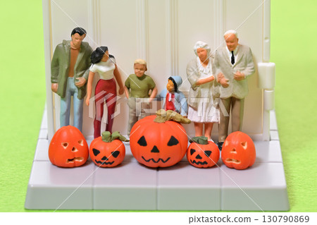 A commemorative photo of the family and a haunted pumpkin in front of the entrance - Halloween 130790869