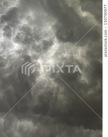 Vertical background image 2 of a dark gray cloudy sky covered with rain clouds 130790977