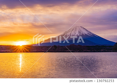 [Yamanashi Prefecture] A golden-hued sky and Mount Fuji at dawn in Japan 130792253