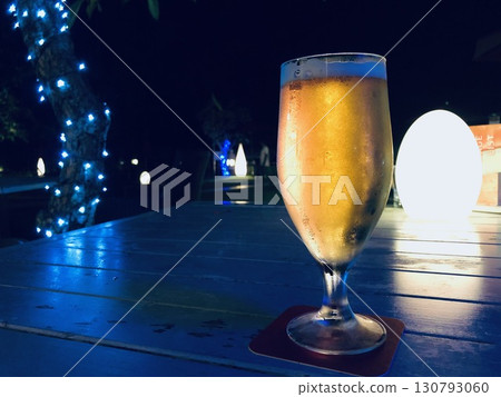 A glass of beer on the terrace at night 130793060