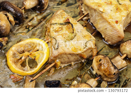 Baked tuna with mushrooms, kebabs. 130793172