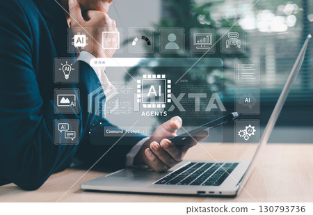 Businessman using laptop and smartphone with AI agents holographic interface. Artificial intelligence for automation, chatbots, data analytics and digital transformation in smart business. Businessman using laptop and smartphone with AI agents holographic interface. Artificial intelligence for automation, chatbots, data analytics and digital transformation in smart business. 130793736