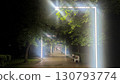 A modern alley at night with glowing linear light installations, creating a futuristic and moody atmosphere in a city park 130793774
