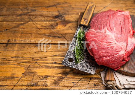 Fresh Raw Round Silverside beef meat cut, inside round with hrebs for roasting. wooden background. Top view 130794037
