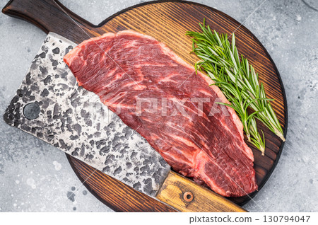 Raw top sirloin cut or rump steak, fresh beef meat. grey background. top view Raw top sirloin cut or rump steak, fresh beef meat. grey background. top view 130794047