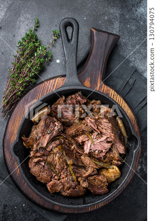 Beef bourguignon stew with tender beef in a pan. black background. top view Beef bourguignon stew with tender beef in a pan. black background. top view 130794075