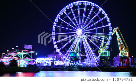 Szczecin, Poland. 16 July 2025. Ferris wheel on the river at night 130794781