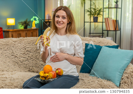 Pregnant woman eats apples bananas healthy snack thumbs up cares health indoor break smiling joyful 130794835