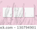 Natural light casts shadows from the field grass on 3 square sheets of white paper lying on a pink background. Mockup 130794901