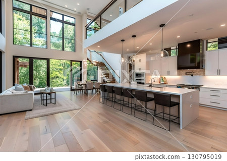 Modern open plan kitchen and living room showing forest view 130795019