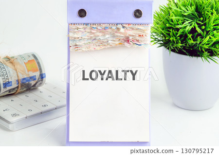 LOYALTY text written on a desktop calendar on a white background. Customer review satisfaction feedback survey concept 130795217