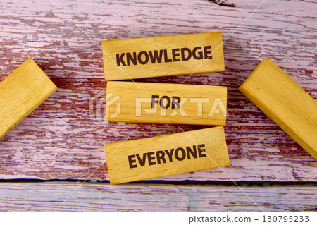 Education Concept text KNOWLEDGE FOR EVERYONE is assembled from blocks on wooden boards, top view 130795233