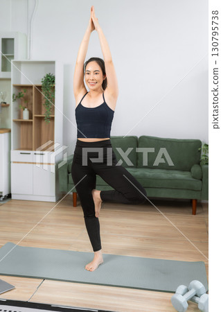 Healthy woman workout at home, exercise, fit, doing yoga, home fitness concept. healthy lifestyle. 130795738