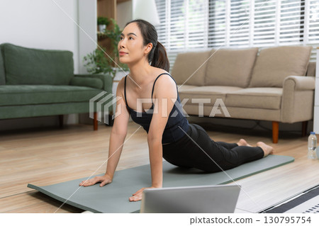 Healthy woman workout at home, exercise, fit, doing yoga, home fitness concept. healthy lifestyle. 130795754