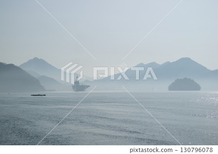 A floating island in the sea and the silhouette of the destroyer Shuga A floating island in the sea and the silhouette of the destroyer Shuga 130796078