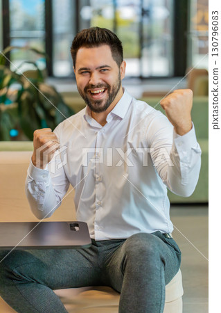 Camera view of amazed shocked young blond woman looking into camera celebrate success in hotel lobby 130796083