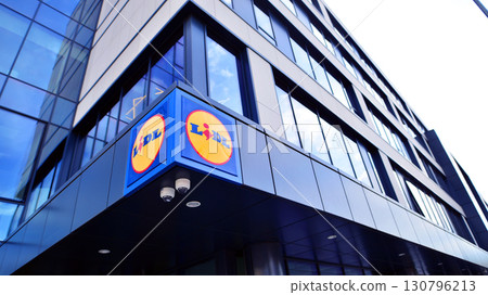 Szczecin, Poland. 16 July 2025. Urban landscape. Neon sign with the inscription: Lidl. Szczecin, Poland. 16 July 2025. Urban landscape. Neon sign with the inscription: Lidl. 130796213