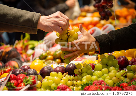 Buying vegetables and fruits in central market in Valencia, Spain Buying vegetables and fruits in central market in Valencia, Spain 130797275
