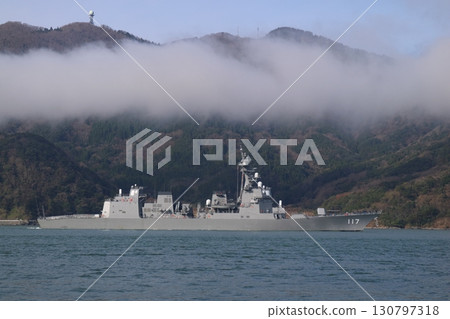 An escort ship sailing through the foggy sea An escort ship sailing through the foggy sea 130797318