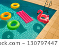 Colorful inflatable pool toys floating in a clear blue swimming pool under bright sunlight 130797447