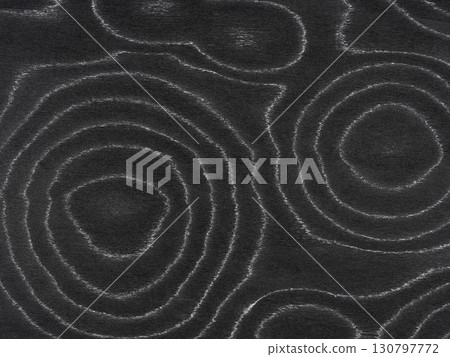 Silver filigree lines etch through the charcoal canvas, bringing a silken sheen to the mesmerizing ebony veneer 130797772