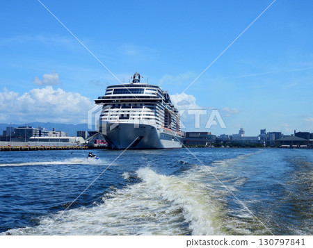 Ocean scenery with a luxury cruise ship anchored 130797841