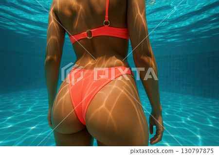 Underwater Coral Bikini Back With Sunlit Caustics In Pool 130797875