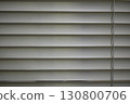 Calm white horizontal blind window close up view. simple texture background with pattern of straight parallel line and shadow creating private 130800706