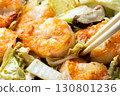 Chinese-style stir-fry of shrimp, shiitake mushrooms and Chinese cabbage, cooking scene. 130801236