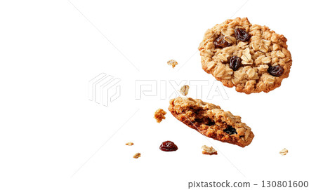 Freshly baked crumbly oatmeal raisin cookies falling on a white background with scattered crumbs and a rustic homemade appearance 130801600