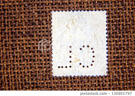 Rare Postage Stamps With Perfins on a Textured Background for Philatelic Fans Rare Postage Stamps With Perfins on a Textured Background for Philatelic Fans 130801797