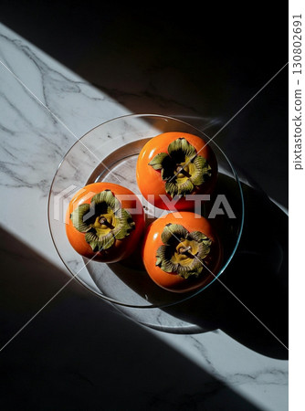 Persimmons on a marble table 130802691