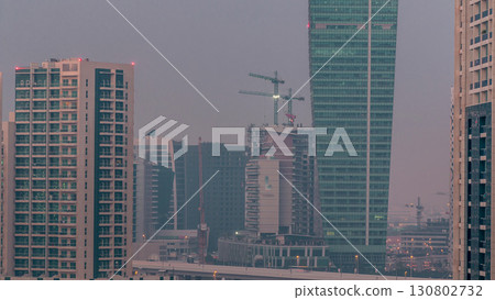Beautiful view of new modern skyscrapers in luxury Dubai timelapse aerial. From night to day transition 130802732