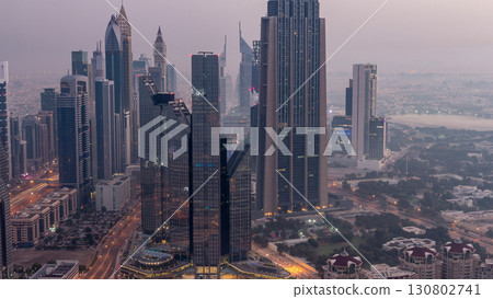 Dubai International Financial Centre district with modern skyscrapers night to day timelapse Dubai International Financial Centre district with modern skyscrapers night to day timelapse 130802741