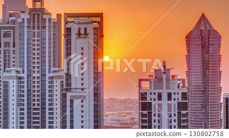 Sunset behind modern residential and office complex aerial timelapse at Business Bay, Dubai 130802758