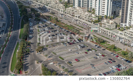 Aerial view full cars at large outdoor parking lots timelapse in Dubai, UAE. 130802764