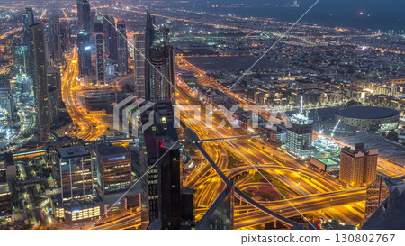 Dubai Downtown skyline futuristic cityscape with many skyscrapers and Burj Khalifa aerial night to day timelapse. 130802767