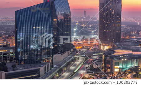 Dubai downtown street with busy traffic and skyscrapers around night to day timelapse. 130802772