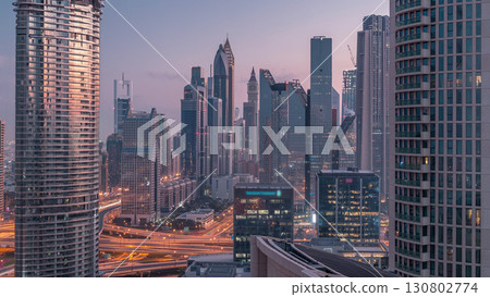 Aerial view of new skyscrapers and tall buildings in Dubai night to day timelapse Aerial view of new skyscrapers and tall buildings in Dubai night to day timelapse 130802774