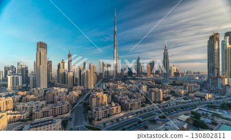 Dubai Downtown skyline timelapse with Burj Khalifa and other towers during sunrise panoramic view from the top in Dubai 130802811