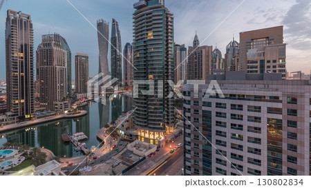 Aerial view of Dubai Marina residential and office skyscrapers with waterfront night to day timelapse 130802834