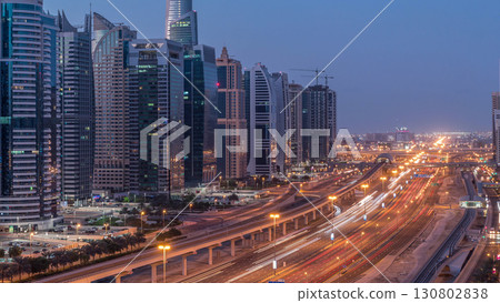 Aerial top view to Sheikh Zayed road near Dubai Marina and JLT night to day timelapse, Dubai. Aerial top view to Sheikh Zayed road near Dubai Marina and JLT night to day timelapse, Dubai. 130802838