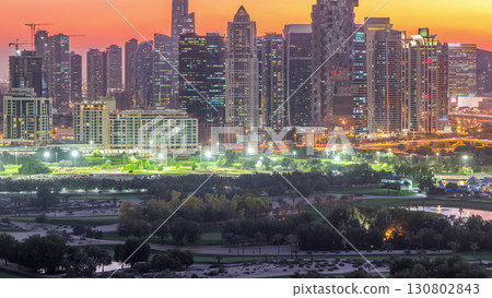 Jumeirah lake towers skyscrapers and golf course day to night timelapse, Dubai, United Arab Emirates 130802843