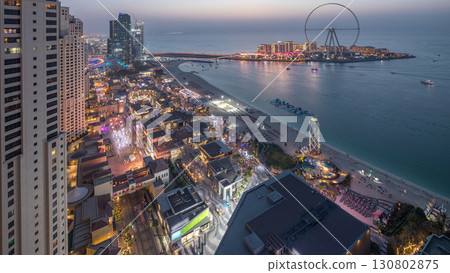 Waterfront overview Jumeirah Beach Residence JBR skyline aerial day to night timelapse with yacht and boats 130802875