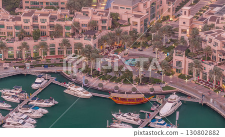 Aerial top view of Dubai Marina day to night timelapse. Modern towers and traffic on the road Aerial top view of Dubai Marina day to night timelapse. Modern towers and traffic on the road 130802882
