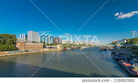 The Austerlitz viaduct in Paris timelapse hyperlapse, seen from bank of the river Seine with a metro train passing 130802982